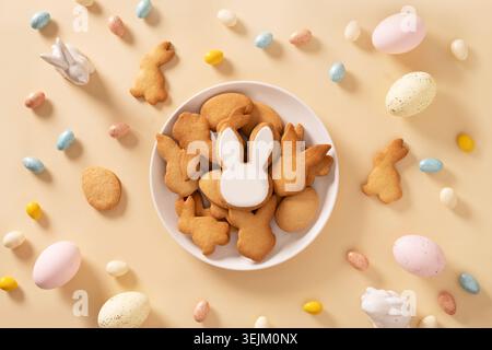 Easter bunny glazed cookies on blue background. Top view. Stock Photo