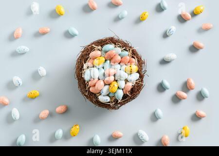 Easter colorful chocolate eggs in decorative nest. Stock Photo