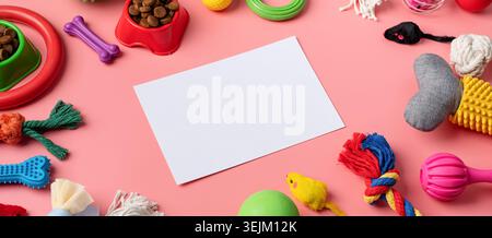 Pet care concept, various pet accessories and tools on pink background with blank paper, high angle view Stock Photo
