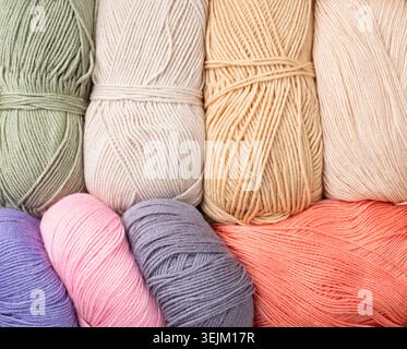 Pastel colored yarn wool on shopfront. Knitting background, a lot of balls. Knitting yarn for handmade winter clothes Stock Photo