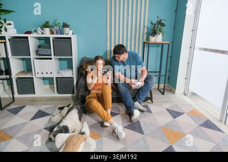 Young family playing video games on console Stock Photo