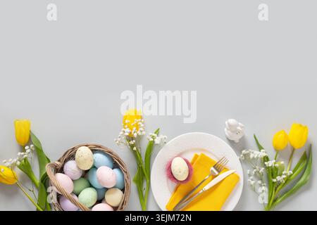Easter mock up with pastel yellow eggs on gray background. Stock Photo