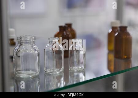 Empty Medical Glass Bottles and Vials on Display Shelf Stock Photo