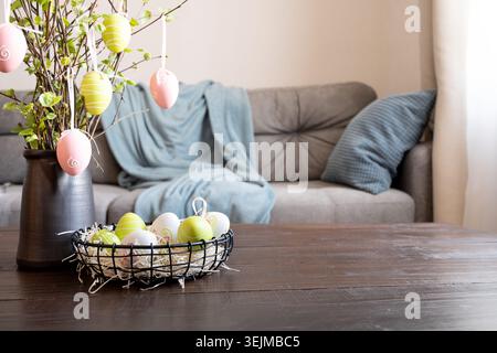 Spring home interior with Easter tree and vase with colorful Self isolation. Stock Photo