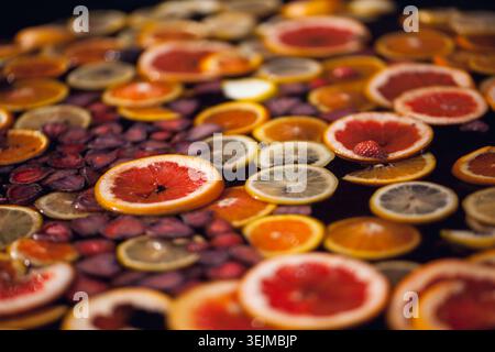 Assorted citrus slices floating gracefully in clear water Stock Photo