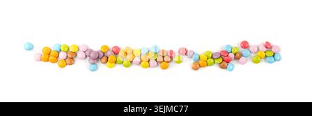 Scattered small candies isolated. Colorful dragees, multicolored glazed chocolate buttons, various dragee collection, rainbow candies on white backgro Stock Photo