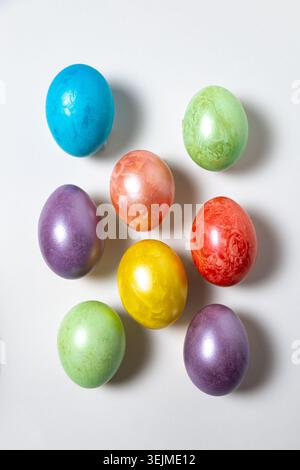 Close-up of vibrant Easter eggs collection arranged on a plain white background Stock Photo