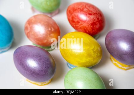 Close-up of vibrant Easter eggs collection arranged on a plain white background Stock Photo