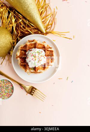 Birthday party waffles with youghurt and colorful sprinkles on pastel background Stock Photo