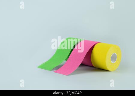 Three rolls kinesiology tape on blue background. Stock Photo