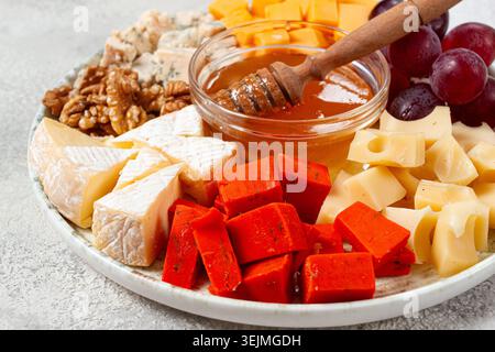 Appetizer, assorted cheese, with nuts and honey, on a round plate, top view, no people, Stock Photo