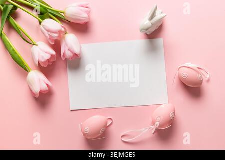 Easter frame with eggs, pink tulips on pink. Stock Photo