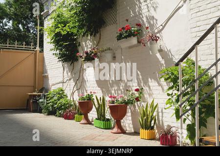 Colorfull floral street with white brick wall in Mediterranean town Stock Photo