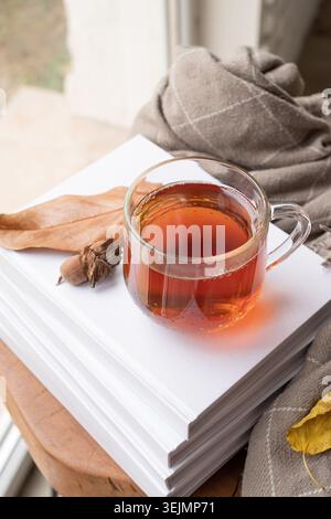 Cozy autumn composition, sweater weather. Yellow leaves, hot tea and sweaters Stock Photo