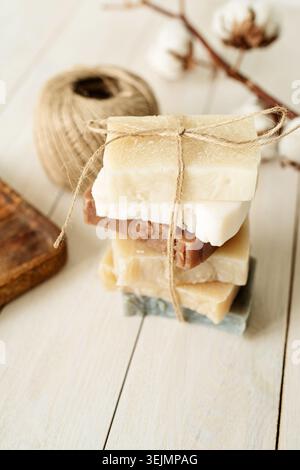 Stack of hand made soap on white wooden background Stock Photo