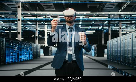 Data center admin using virtual reality simulation technology to monitor systems. Server room system administrator using VR goggles equipment to do optimizations, VFX overlay, camera A Stock Photo