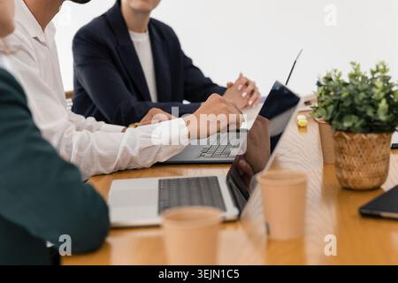 Business professionals collaborating at office meeting table Stock Photo