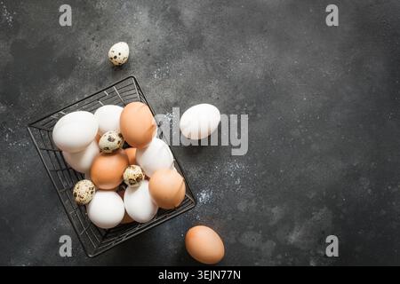 Organic white and brown chicken eggs in box. Top view. Vintage dark. Stock Photo