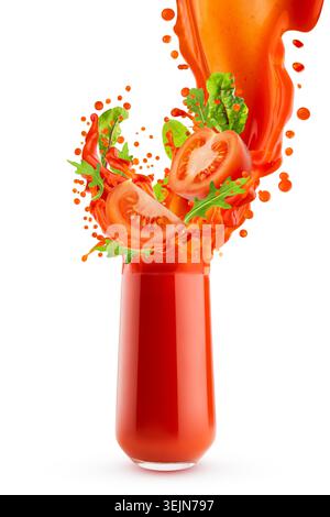 Fresh red vegetable juice pouring into glass with flying tomato slices, green vegetable leaves, arugula, dynamic flows, splashes Stock Photo