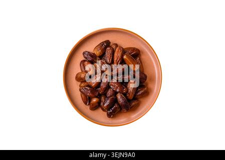 Dried dates on a ceramic plate for Ramadan or Iftar. Dates fruit as a background Stock Photo