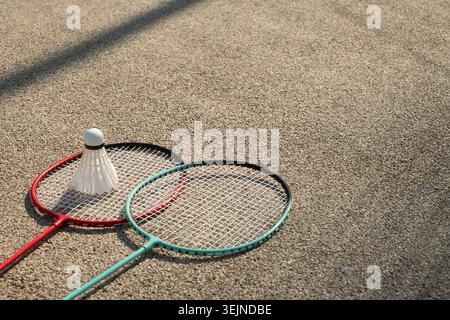 White badminton shuttlecock and badminton rackets on floor sport badminton. Stock Photo