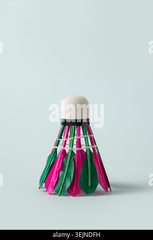 Colorful feather badminton shuttlecock on blue background. Close up. Stock Photo