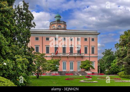 Magnificent Villa Ciani building in the park of Lugano city, Switzerland. Clear blue sky with few clouds in sunny June Stock Photo