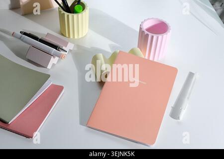 Pastel colored stationery on white desk Stock Photo