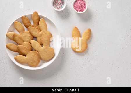 Easter cookies shaped of eggs and bunny in white plate. Stock Photo