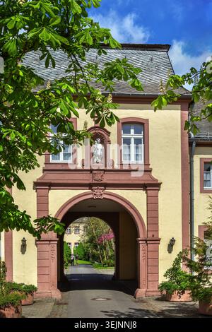 Steinfeld Abbey gatehouse facade with sculpture in Steinfeld Germany. Close up view of historic monastic architecture Stock Photo