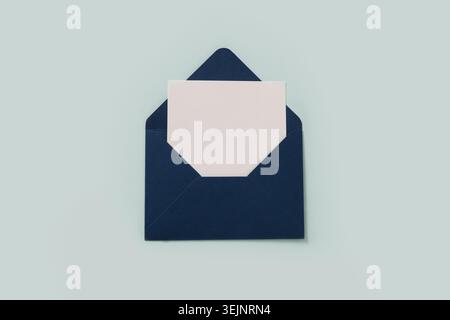 Blue paper envelope on blue background. View from above. Stock Photo