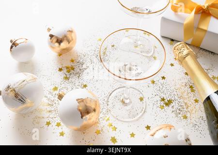 Xmas composition with gold balls, champagne bottle. New Year greeting card. Stock Photo