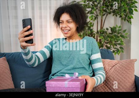 Young woman having video call sharing gift and happiness Stock Photo
