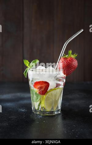 Detox lemonade or mojito with lime, lemon, strawberry in rocks glass. Summer healthy drink. Stock Photo