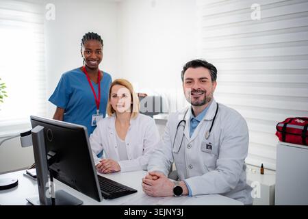 Healthcare professionals collaborating, working in a modern clean medical office Stock Photo