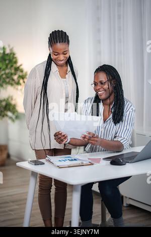 Colleagues collaborating on business project in modern office Stock Photo