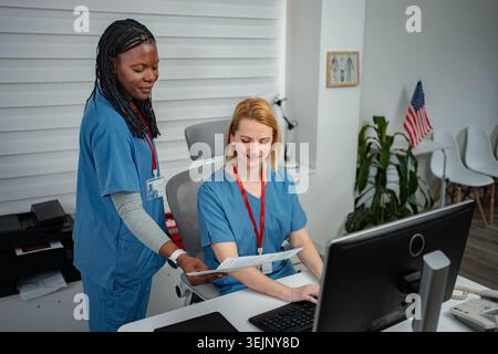 Healthcare professionals collaborating on computer in office Stock Photo