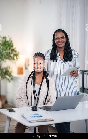Successful Black businesswomen collaborating in modern office setting Stock Photo