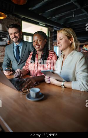 Diverse business professionals smiling, collaborating and working together Stock Photo