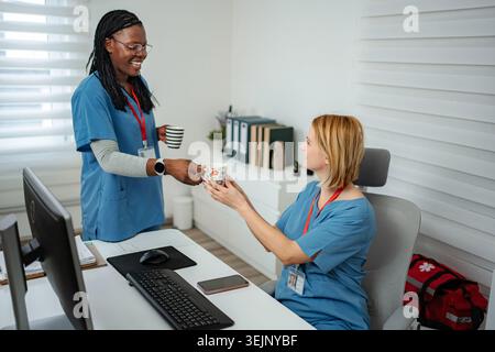 Healthcare workers enjoying coffee break in clinic office Stock Photo