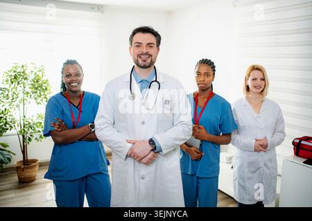Diverse group of healthcare professionals confidently standing in a medical office Stock Photo