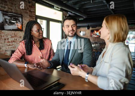 Business colleagues collaborating on new project in informal setting Stock Photo