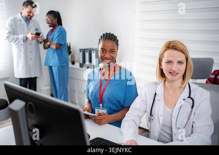 Diverse team of medical professionals working together in clinic Stock Photo
