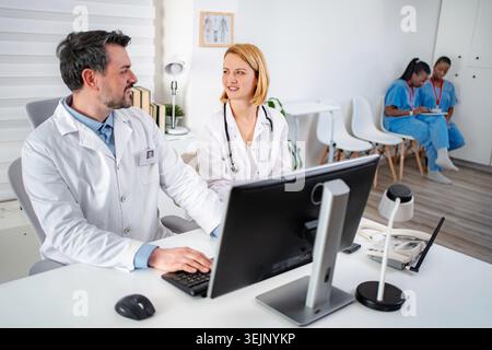 Doctors and nurses working together in hospital clinic office Stock Photo