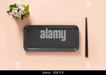 Empty rectangular plate with chopsticks and spring branches decoration Stock Photo