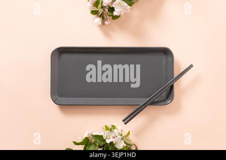 Empty rectangular plate with chopsticks and spring branches decoration Stock Photo