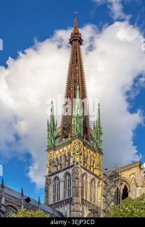 Rouen Cathedral, France, low angle view of main tower. High gothic stone architecture under partly cloudy daylight sky Stock Photo