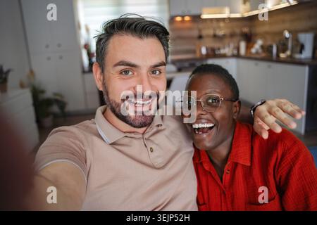 Happy couple taking a selfie at home Stock Photo