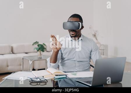 African american male architect designer in VR glasses works on interior project in virtual reality Stock Photo