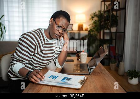 Stressed young adult woman working from home having problems Stock Photo